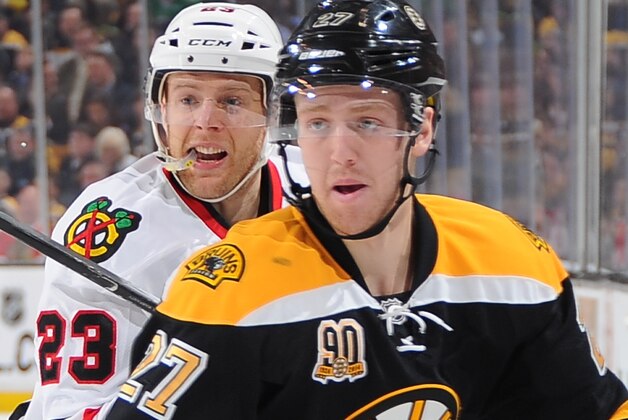 BOSTON, MA - MARCH 27: Dougie Hamilton #27 of the Boston Bruins skates against Kris Versteg #23 of the Chicago Blackhawks at the TD Garden on March 27, 2014 in Boston, Massachusetts.  (Photo by Steve Babineau/NHLI via Getty Images)