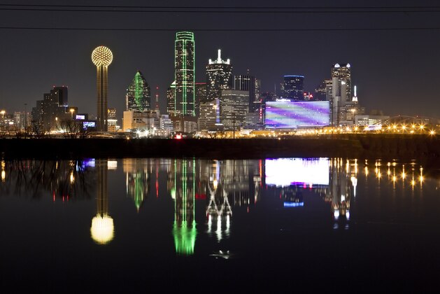 FILE - In this  Jan. 26, 2012 file photo, the Dallas skyline is reflected in the Trinity River in Dallas. The odds of hosting the Republican Party’s next presidential convention have improved for Dallas, Denver, Cleveland and Kansas City. Two other players, Las Vegas and Cincinnati, have folded. The four remaining cities will be making in-city pitches to party officials looking for a host with ample meeting space, hotels and transportation to accommodate tens of thousands of visitors. (AP Photo/Brandon Wade, File)