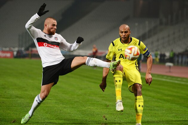ISTANBUL, TURKEY - DECEMBER 11:  Gokhan Tore of Besiktas challenges Younes Kaboul of Spurs during the UEFA Europa League Group C match between Besiktas JK and Tottenham Hotspur FC at Ataturk Olympic Stadium on December 11, 2014 in Istanbul, Turkey.  (Photo by Jamie McDonald/Getty Images)