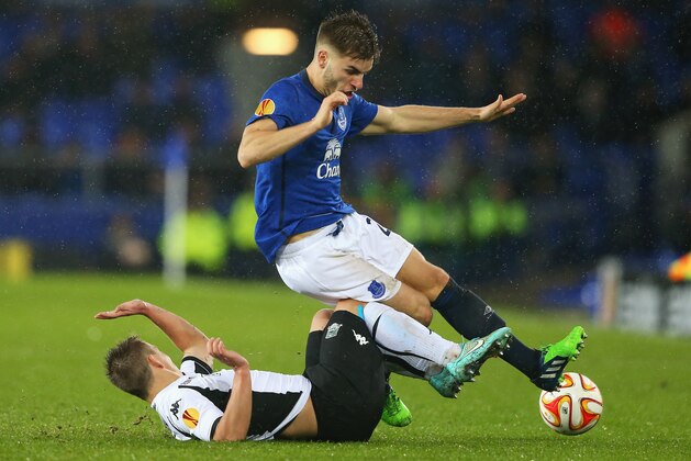 LIVERPOOL, ENGLAND - DECEMBER 11: Luke Garbutt of Everton is challenged by Sergei Petrov of Krasnodar during the UEFA Europa League Group H match between Everton and Krasnodar at Goodison Park on December 11, 2014 in Liverpool, England.  (Photo by Alex Livesey/Getty Images)