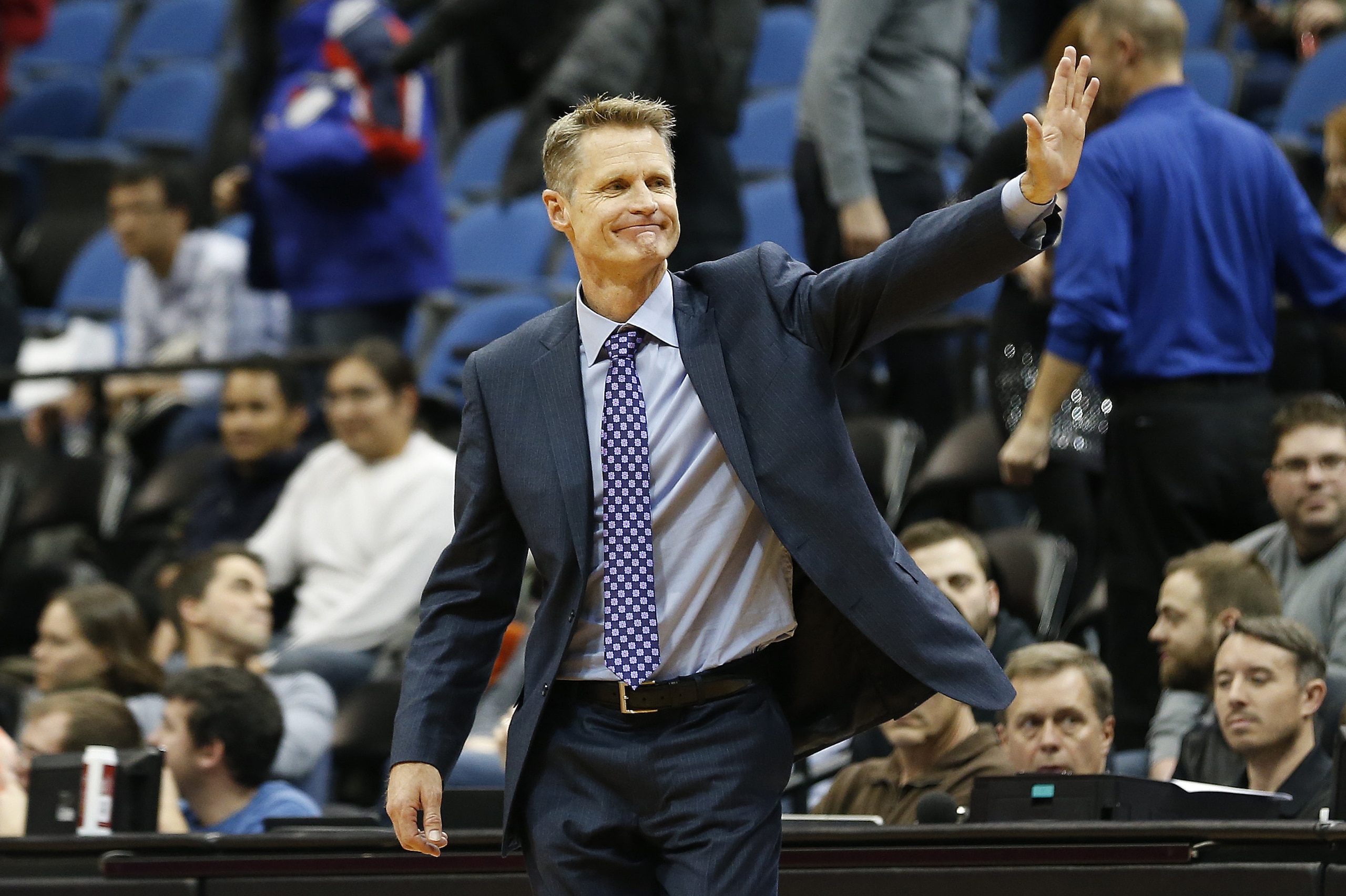 Golden State Warriors head coach Steve Kerr acknowledges his team's 102-86 win over the Minnesota Timberwolves in an NBA basketball game Monday, Dec, 8, 2014, in Minneapolis. (AP Photo/Stacy Bengs)