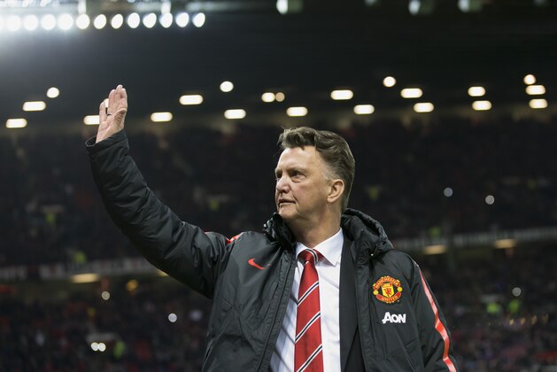 Manchester United manager Louis van Gaal waves to supporters before the English Premier League soccer match between Manchester United and Stoke City at Old Trafford Stadium, Manchester, England, Tuesday Dec. 2, 2014. (AP Photo/Jon Super)