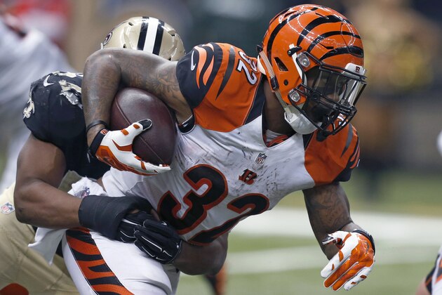 Cincinnati Bengals running back Jeremy Hill (32) carries as New Orleans Saints inside linebacker David Hawthorne (57) tackles in the second half of an NFL football game in New Orleans, Sunday, Nov. 16, 2014. The Bengals won 27-10.  (AP Photo/Rogelio Solis)