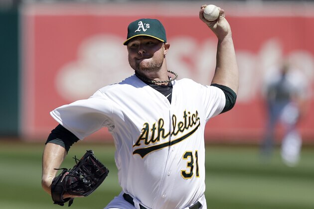 FILE - In this Sept. 3, 2014, file photo, Oakland Athletics pitcher Jon Lester throws against the Seattle Mariners during the first inning of a baseball game in Oakland, Calif. A person familiar with the negotiations says pitcher Lester has agreed to a $155 million, six-year contract with the Chicago Cubs. The person spoke on condition of anonymity Tuesday, Dec. 9, because the agreement had not been announced. (AP Photo/Jeff Chiu, File)