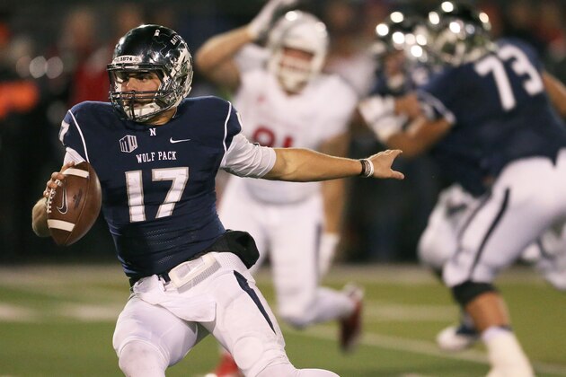 Nevada quarterback Cody Fajardo scrambles under pressure from Fresno State during the first half of an NCAA college football game in Reno, Nev., on Saturday, Nov. 22, 2014. Fresno State won 40-20. (AP Photo/Cathleen Allison)