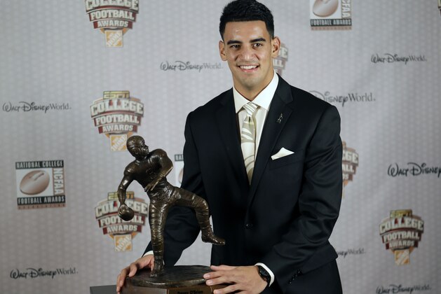 Oregon's Marcus Mariota stands with his trophy after being awarded the Davey O'Brien Award for Nation's Best Quarterback at the College Football Awards, Thursday, Dec. 11, 2014, in Lake Buena Vista, Fla. (AP Photo/John Raoux)