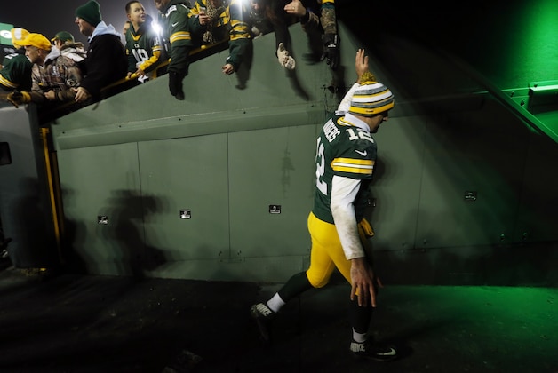 Green Bay Packers' Aaron Rodgers celebrates with fans on his way to the locker room after an NFL football game against the Atlanta Falcons Monday, Dec. 8, 2014, in Green Bay, Wis. The Packers won 43-37. (AP Photo/Mike Roemer)