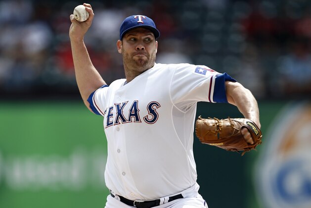 Texas Rangers starting pitcher Colby Lewis delivers to the Atlanta Braves during the first inning of a baseball game, Sunday, Sept. 14, 2014, in Arlington, Texas. (AP Photo/Jim Cowsert)