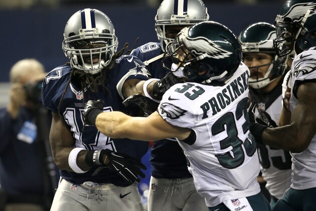 Dallas Cowboys' Dwayne Harris (17) takes a swing at Philadelphia Eagles' Chris Prosinski (33) as a fight broke out after the Cowboys punted the ball during the second half of an NFL football game, Thursday, Nov. 27, 2014, in Arlington, Texas. The Eagles won 33-10. (AP Photo/Tim Sharp)