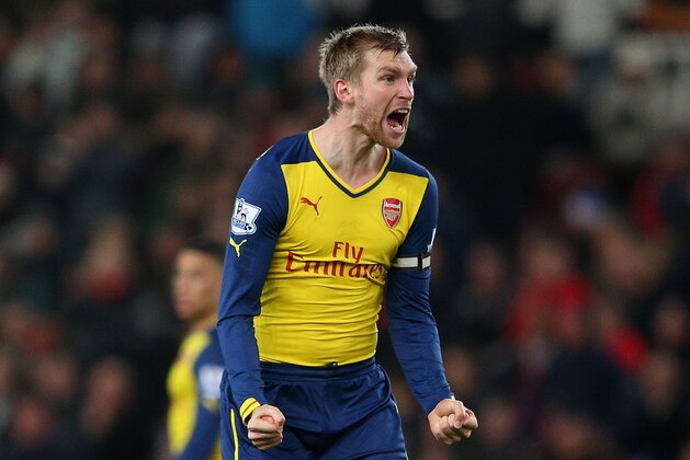 STOKE ON TRENT, ENGLAND - DECEMBER 06:  Per Mertesacker of Arsenal reacts after his team's second goal during the Barclays Premier League match between Stoke City and Arsenal  at the Britannia Stadium on December 6, 2014 in Stoke on Trent, England.  (Photo by Clive Mason/Getty Images)