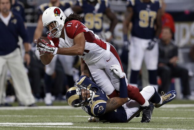 Arizona Cardinals' Larry Fitzgerald (11) is tackled by St. Louis Rams' Trumaine Johnson (22) during the second half of an NFL football game Thursday, Dec. 11, 2014 in St. Louis. (AP Photo/Jeff Roberson)