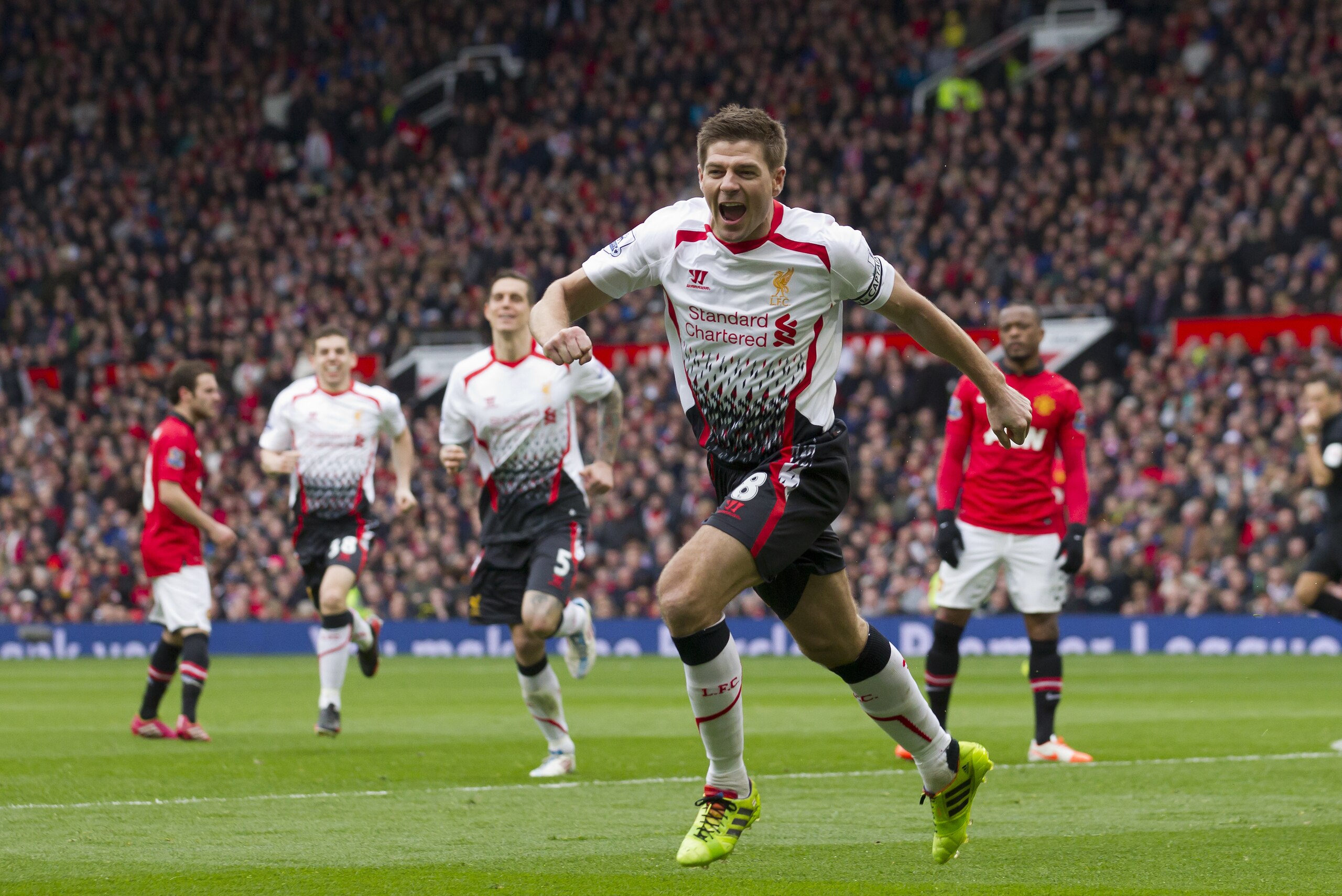 Liverpool's Steven Gerrard celebrates after scoring against Manchester United during their English Premier League soccer match at Old Trafford Stadium, Manchester, England, Sunday March 16, 2014. (AP Photo/Jon Super)