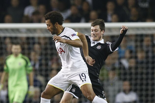 Tottenham's Mousa Dembele, left, competes for the ball with Nikola Ninkovic during the Europa League group C soccer match between Tottenham Hotspur and Partizan Belgrade at White Hart Lane stadium in London, Thursday, Nov. 27, 2014 .(AP Photo/Alastair Grant)
