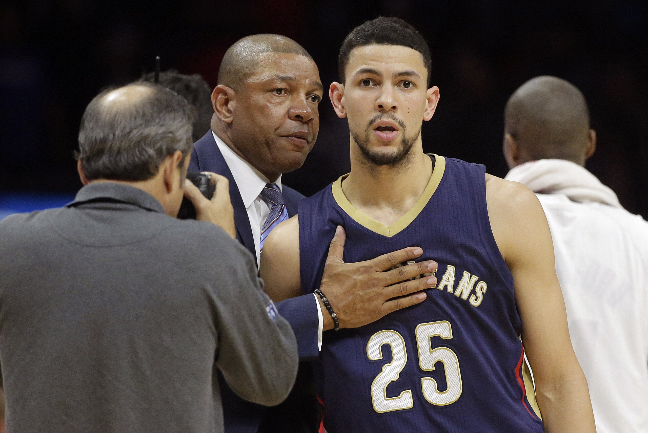 Los Angeles Clippers head coach Doc Rivers, left, hugs his son, New Orleans Pelicans' Austin Rivers after an NBA basketball game Saturday, Dec. 6, 2014, in Los Angeles. The Clippers won 120-100. (AP Photo/Jae C. Hong)