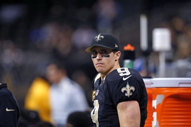 New Orleans Saints quarterback Drew Brees (9) watches from the bench in the second half of an NFL football game against the Carolina Panthers in New Orleans, Sunday, Dec. 7, 2014. The Panthers won 41-10. (AP Photo/Bill Haber)