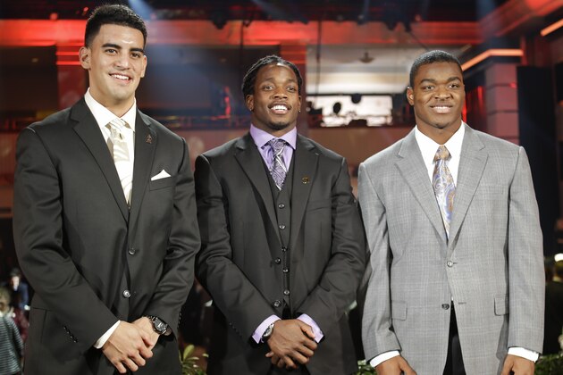 Heisman Trophy candidates, from left, Oregon's Marcus Mariota, Wisconsin's Melvin Gordon and Alabama's Amari Cooper pose for a photo at the College Football Awards, Thursday, Dec. 11, 2014, in Lake Buena Vista, Fla. The winner of the Heisman Trophy will be announced on Saturday. (AP Photo/John Raoux)