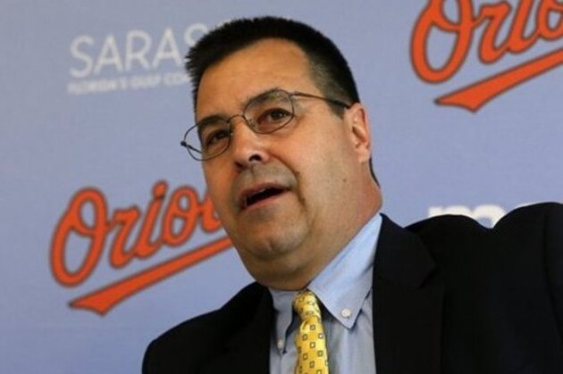 Baltimore Orioles Executive Vice-President of Baseball Operations Dan Duquette introduces Nelson Cruz to the media during a news conference at the Ed Smith Stadium complex before the team's baseball spring training workout in Sarasota, Fla., Tuesday, Feb. 25, 2014. (AP Photo/Gene J. Puskar)