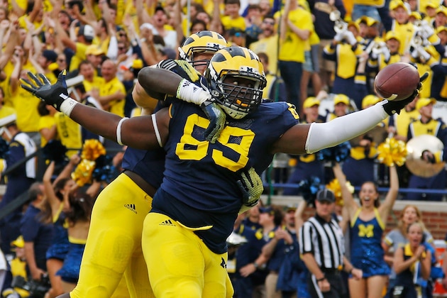 ANN ARBOR, MI - SEPTEMBER 20:  Willie Henry #69 of the Michigan Wolverines celebrates a second quarter interception for a touchdown with Mario Ojemudia #53 and Brennen Beyer #97 while playing the Utah Utes on September 20, 2014 at Michigan Stadium in Ann Arbor, Michigan.  (Photo by Gregory Shamus/Getty Images)
