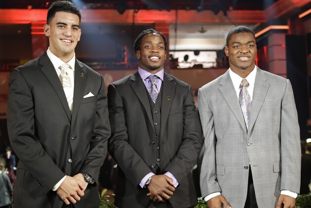 Heisman Trophy candidates, from left, Oregon's Marcus Mariota, Wisconsin's Melvin Gordon and Alabama's Amari Cooper pose for a photo at the College Football Awards, Thursday, Dec. 11, 2014, in Lake Buena Vista, Fla. The winner of the Heisman Trophy will be announced on Saturday. (AP Photo/John Raoux)