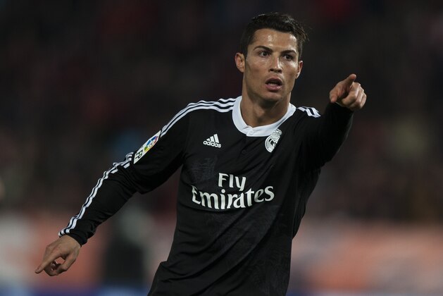 Real Madrid's Cristiano Ronaldo from Portugal, celebrates his second goal against UD Almeria's, during a Spanish La Liga soccer match at the Juegos Mediterraneos stadium in Almeria, southeast Spain, Friday, Dec. 12, 2014. (AP Photo/Daniel Tejedor)