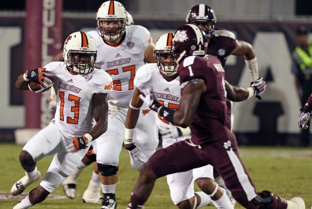 Bowling Green running back Travis Greene (13) evades Mississippi State defensive back Nickoe Whitley (1) for a gain in the first half of their NCAA college football game in Starkville, Miss., Saturday, Oct. 12, 2013. (AP Photo/Kerry Smith)