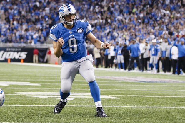 Detroit Lions quarterback Matthew Stafford (9) celebrates a touchdown against the Chicago Bears during an NFL football game at Ford Field in Detroit, Thursday, Nov. 27, 2014. (AP Photo/Rick Osentoski)