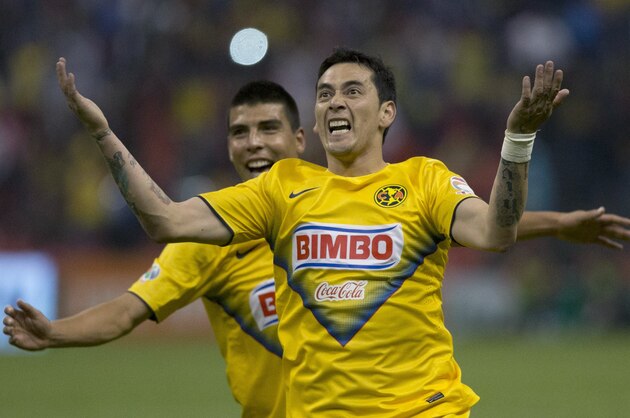America's Rubens Sambueza, celebrates after scoring against Santos during a Mexican soccer league match in Mexico City, Wednesday, April 30, 2014.(AP Photo/Eduardo Verdugo)