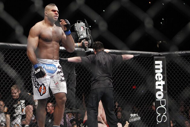 Alistair Overeem, of the Netherlands, celebrates his first round TKO victory over Brock Lesnar, right, after their UFC 141 heavyweight mixed martial arts match, Friday, Dec. 30, 2011, at The MGM Grand Garden Arena in Las Vegas. Lesnar retired following the fight. (AP Photo/Eric Jamison)
