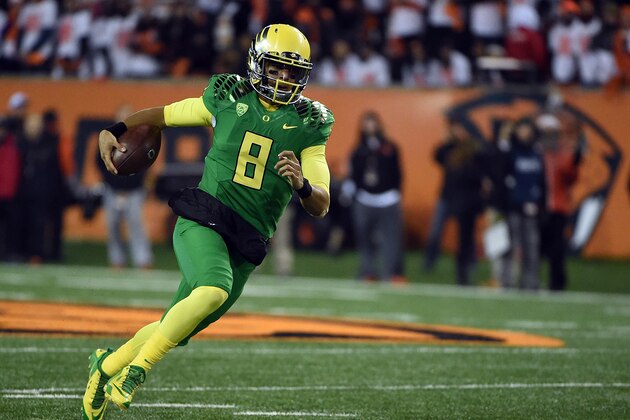 CORVALLIS, OR - NOVEMBER 29:  Quarterback Marcus Mariota #8 of the Oregon Ducks runs with the ball during the third quarter of the game against the Oregon State Beavers at Reser Stadium on November 29, 2014 in Corvallis, Oregon.  (Photo by Steve Dykes/Getty Images)