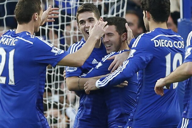 Chelsea's Eden Hazard, third left, celebrates with teammate Chelsea's Oscar after scoring the opening goal of the game during their English Premier League soccer match between Chelsea and Hull City at Stamford Bridge stadium in London, Saturday, Dec 13, 2014. (AP Photo/Alastair Grant)