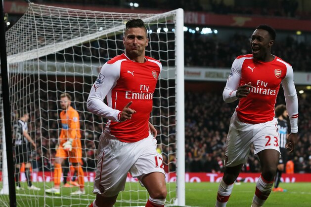 Arsenal’s Oliver Giroud, left, celebrates after scoring a goal, with Arsenal’s Danny Welbeck during the English Premier League soccer match between Arsenal and Newcastle United at the Emirates Stadium, London, Saturday, Dec. 13, 2014. (AP Photo/Tim Ireland)