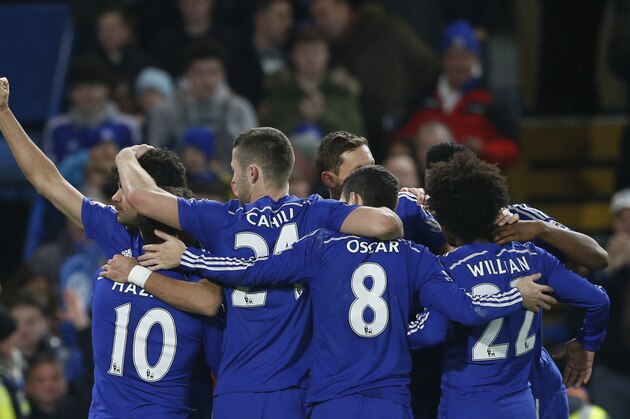 Chelsea's Diego Costa, left,  is mobbed by his teammates after scoring his sides second goal during their English Premier League soccer match between Chelsea and Hull City at Stamford Bridge stadium in London, Saturday, Dec 13, 2014. (AP Photo/Alastair Grant)