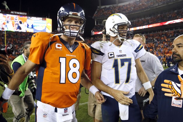Denver Broncos quarterback Peyton Manning (18) greets San Diego Chargers quarterback Philip Rivers (17) after an NFL football game, Thursday, Oct. 23, 2014, in Denver. The Broncos won 35-21. (AP Photo/Jack Dempsey)