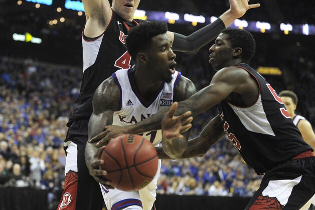 Dec 13, 2014; Kansas City, MO, USA; Kansas Jayhawks forward Jamari Traylor (31) is fouled by Utah Utes guard Delon Wright (55) in the second half at Sprint Center. Kansas won the game 63-60. Mandatory Credit: John Rieger-USA TODAY Sports