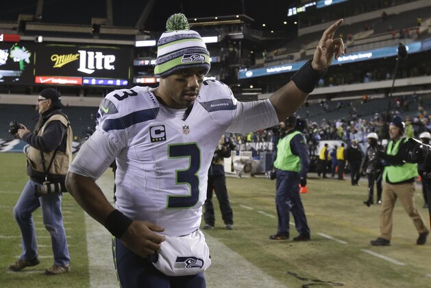 Seattle Seahawks' Russell Wilson runs off the field after an NFL football game against the Philadelphia Eagles, Sunday, Dec. 7, 2014, in Philadelphia. Seattle won 24-14. (AP Photo/Matt Rourke)