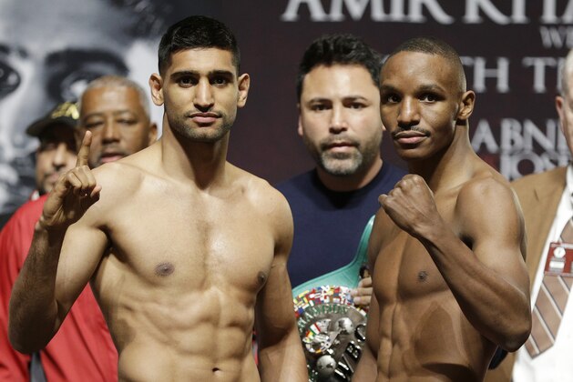 Amir Khan, left, and Devon Alexander pose after a weigh-in Friday, Dec. 12, 2014, in Las Vegas. The two are scheduled to fight in a welterweight bout Saturday in Las Vegas.(AP Photo/John Locher)