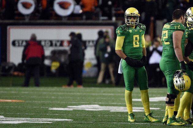 CORVALLIS, OR - NOVEMBER 29: Quarterback Marcus Mariota #8 of the Oregon Ducks looks out from a sideline huddle during the fourth quarter of the game against the Oregon State Beavers at Reser Stadium on November 29, 2014 in Corvallis, Oregon. (Photo by Steve Dykes/Getty Images)