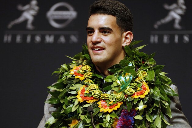 Oregon quarterback Marcus Mariota speaks during a news conference after being awarded the Heisman Trophy, Saturday, Dec. 13, 2014, in New York. (AP Photo/Julio Cortez)
