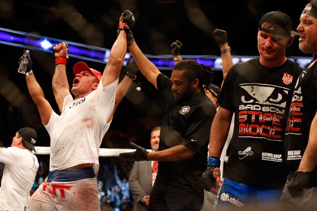 PHOENIX, AZ - DECEMBER 13:  Junior dos Santos (L) celebrates after defeating Stipe Miocic (second from right) by unanimous decision in their heavyweight bout during the UFC Fight Night event at the at U.S. Airways Center on December 13, 2014 in Phoenix, Arizona.  (Photo by Christian Petersen/Getty Images)