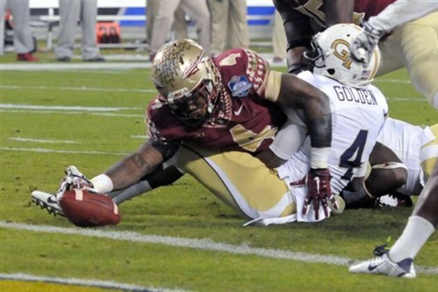 Florida State's Dalvin Cook, left, stretches the ball just short of the goal line as Georgia Tech defensive back Jamal Golden, right, defends during the first half of the Atlantic Coast Conference championship NCAA college football game in Charlotte, N.C., Saturday, Dec. 6, 2014. (AP Photo/Mike McCarn)