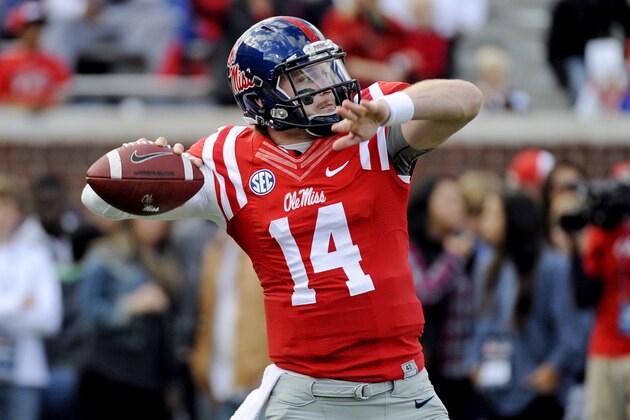 Mississippi quarterback Bo Wallace (14) releases a pass while warming up before an NCAA college football game against Mississippi State in Oxford, Miss., Saturday, Nov. 29, 2014. (AP Photo/Thomas Graning)