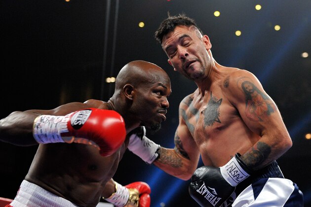 LAS VEGAS, NV - DECEMBER 13:  Timothy Bradley Jr. (L) receives a punch from Diego Chaves during their welterweight bout at The Chelsea at The Cosmopolitan of Las Vegas on December 13, 2014 in Las Vegas, Nevada.  (Photo by David Becker/Getty Images)