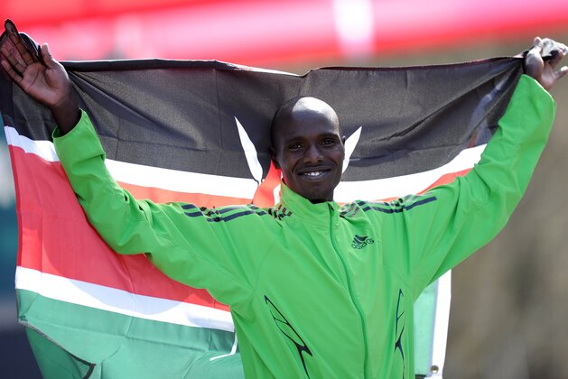 Wilson Chebet of Kenya  displays the Kenyan flag, after winning the Rotterdam Marathon, in Rotterdam, Netherlands, Sunday April 10, 2011. (AP photo/Ermindo Armino)
