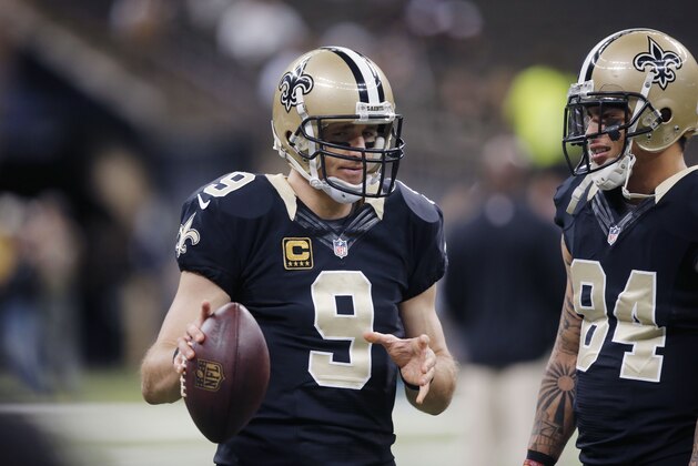 New Orleans Saints quarterback Drew Brees (9) warms up with wide receiver Kenny Stills (84) before an NFL football game in New Orleans, Sunday, Dec. 7, 2014. (AP Photo/Bill Haber)