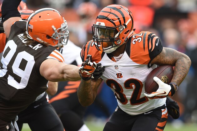CLEVELAND, OH - DECEMBER 14:  Jeremy Hill #32 of the Cincinnati Bengals runs past the defense of Paul Kruger #99 of the Cleveland Browns during the first quarter at FirstEnergy Stadium on December 14, 2014 in Cleveland, Ohio.  (Photo by Jason Miller/Getty Images)