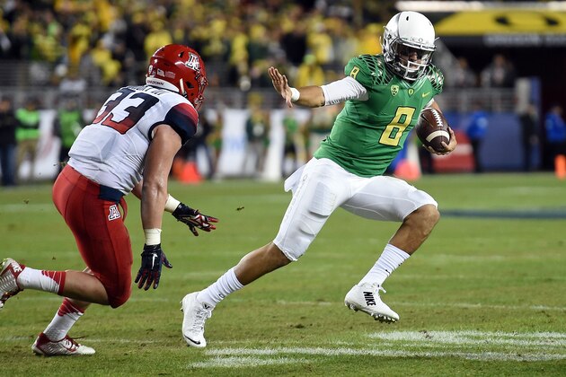 SANTA CLARA, CA - DECEMBER 05:  Marcus Mariota #8 of the Oregon Ducks tries to avoid the tackle of Scooby Wright III #33 of the Arizona Wildcats in the first half during the PAC-12 Championships at Levi's Stadium on December 5, 2014 in Santa Clara, California.  (Photo by Thearon W. Henderson/Getty Images)