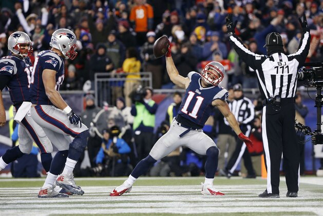 New England Patriots wide receiver Julian Edelman (11) celebrates a touchdown catch from quarterback Tom Brady, far left, in the first half of an NFL football game against the Denver Broncos on Sunday, Nov. 2, 2014, in Foxborough, Mass. Patriots tight end Rob Gronkowski, second from left, watches. (AP Photo/Elise Amendola)