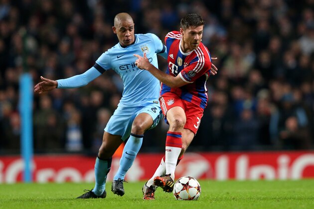 MANCHESTER, ENGLAND - NOVEMBER 25:  Xabi Alonso of Bayern Muenchen goes past the challenge from Fernando of Manchester City during the UEFA Champions League Group E match between Manchester City and FC Bayern Muenchen at the Etihad Stadium on November 25, 2014 in Manchester, United Kingdom.  (Photo by Alex Livesey/Getty Images)
