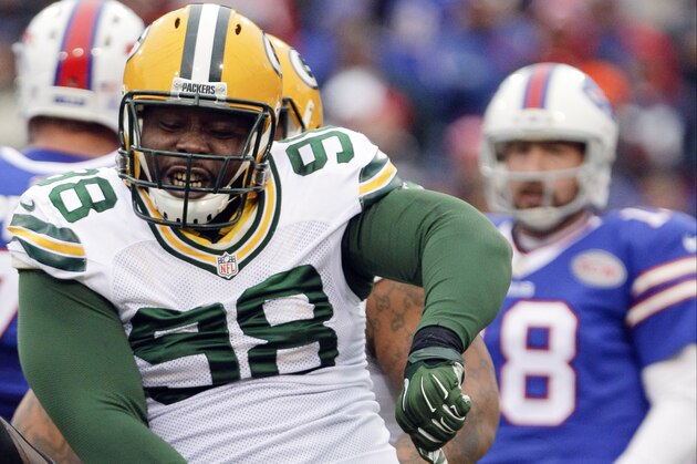Green Bay Packers nose tackle Letroy Guion (98) celebrates a sack of Buffalo Bills quarterback Kyle Orton (18) during the first half of an NFL football game Sunday, Dec. 14, 2014, in Orchard Park, N.Y. (AP Photo/Bill Wippert)