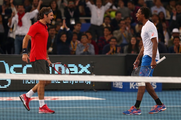 DELHI, INDIA - DECEMBER 08:  Roger Federer of the Indian Aces celebrates match point with his doubles partner and team mate Gael Monfils after their victory  against  Novak Djokovic and Marin Cilic of the UAE Royals during the Coca-Cola International Premier Tennis League third leg at the Indira Gandhi Indoor Stadium December 8, 2014 in Delhi, Delhi.  (Photo by Clive Brunskill/Getty Images for IPTL 2014)